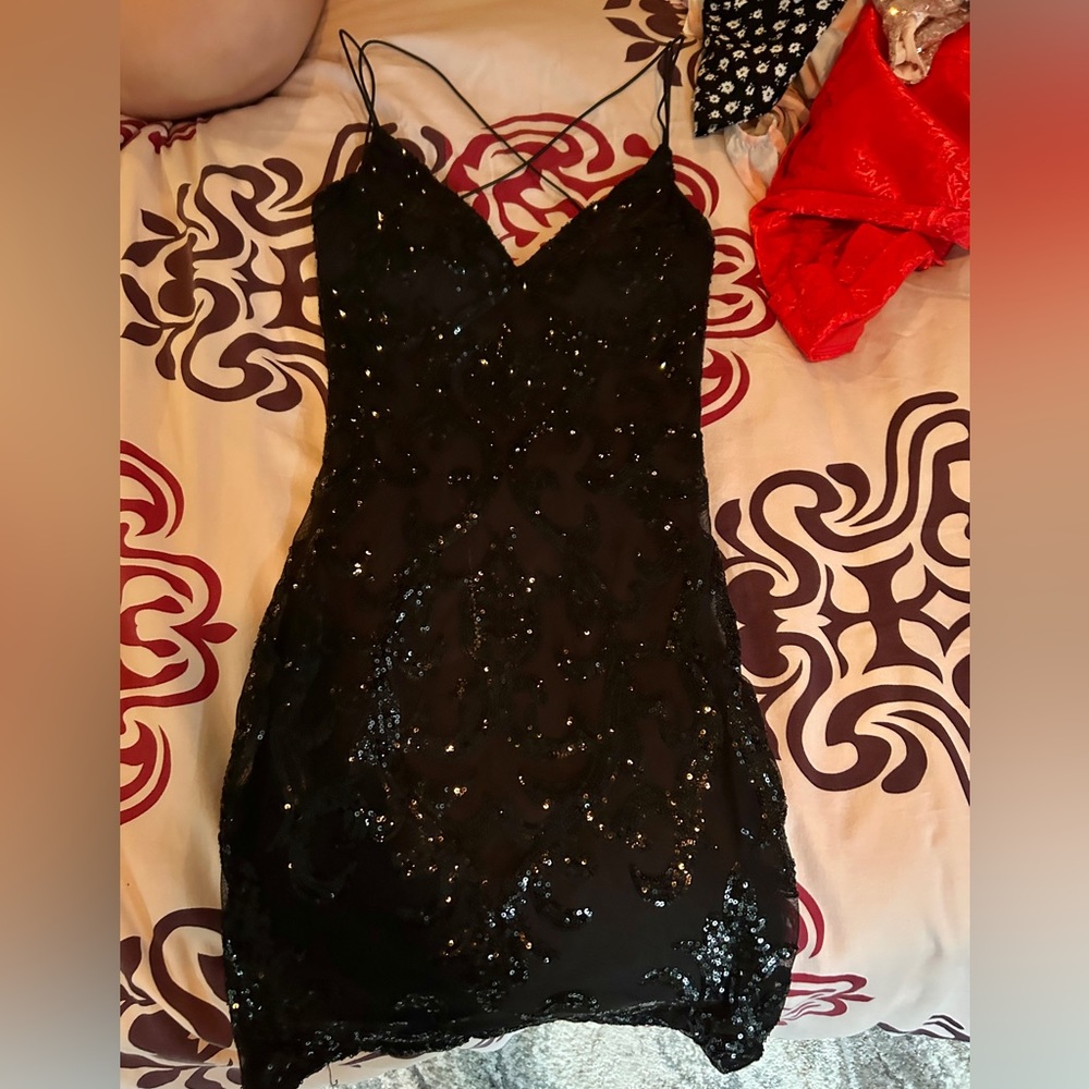 This is a black mini sparkly dress.